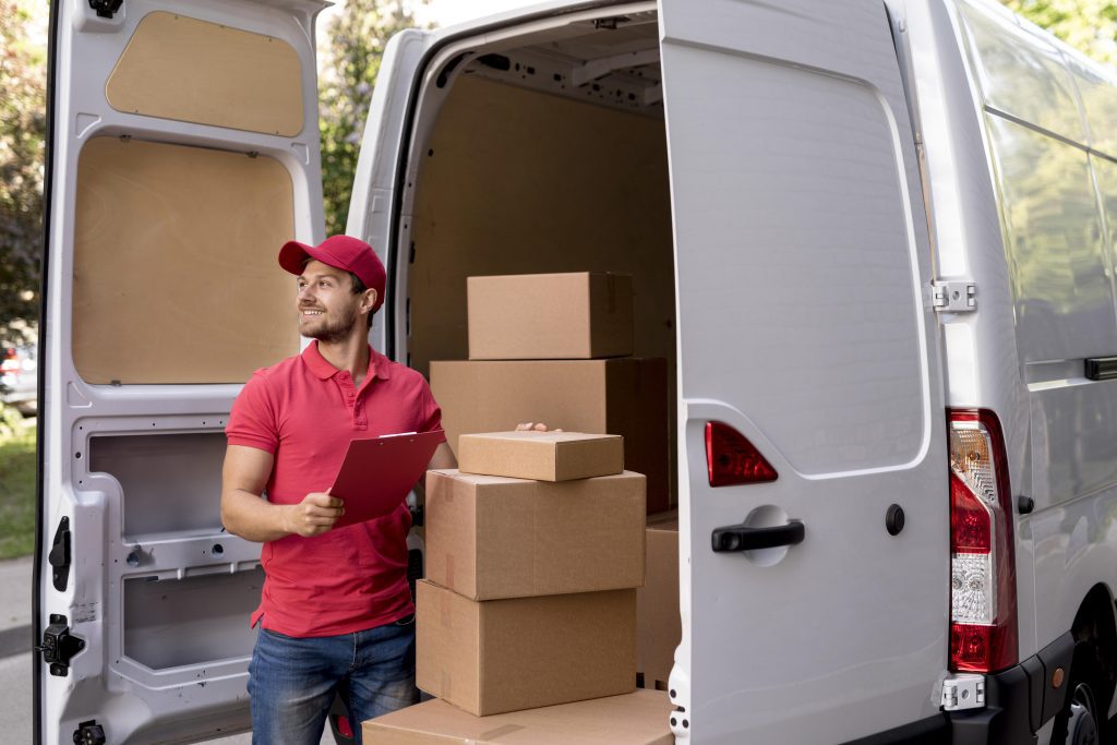 Delivery Man With Packages In Van