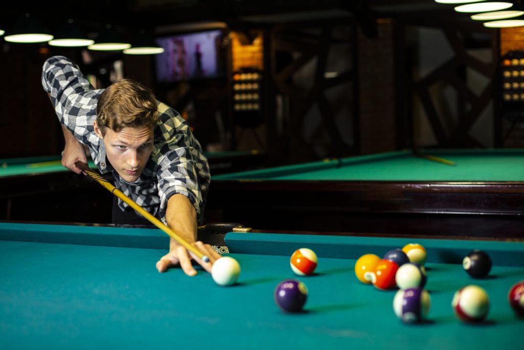 Guy Playing Pool At Pool Table